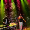 Kyah Fyah in front of Dub Pistol banner