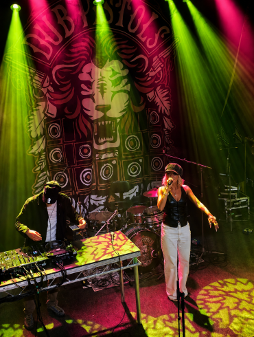 Kyah Fyah in front of Dub Pistol banner