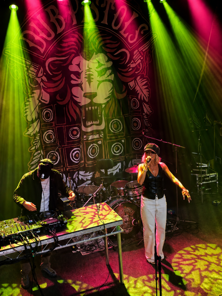 Kyah Fyah in front of Dub Pistol banner
